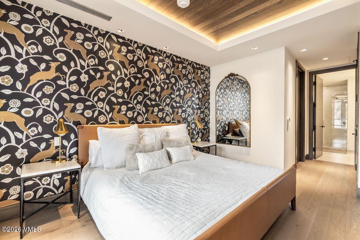 430 South Frontage Road East, Unit RU303 Vail, CO 81657 - Photo 8 of 39 a large bed sitting in a bedroom next to a window