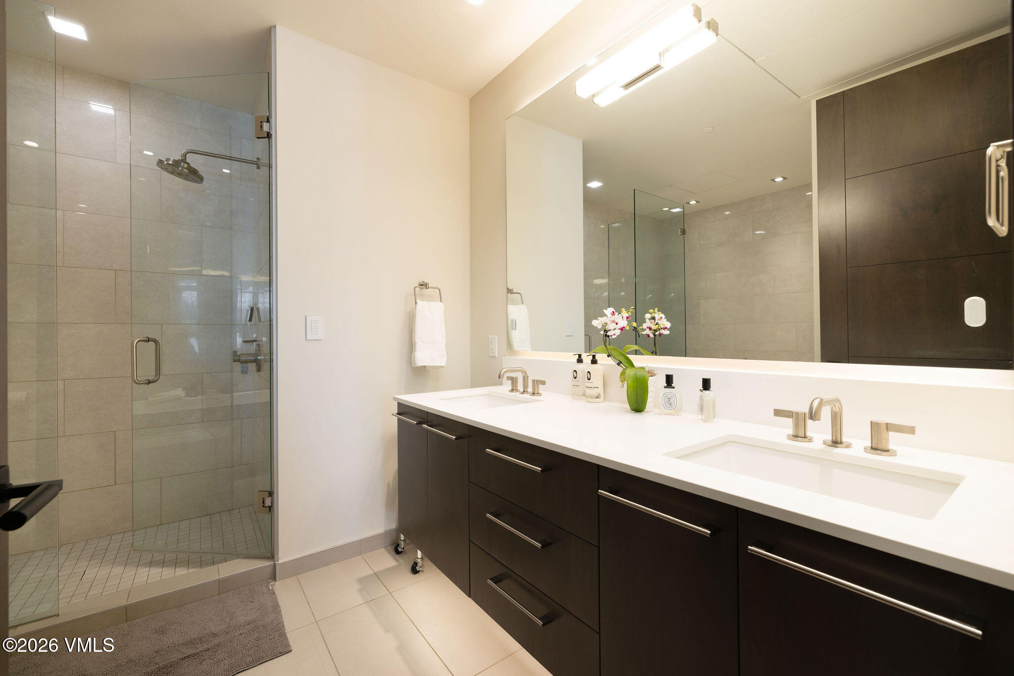 430 South Frontage Road East, Unit RU303 Vail, CO 81657 - Photo 9 of 39 a bathroom with a double vanity sink mirror and shower