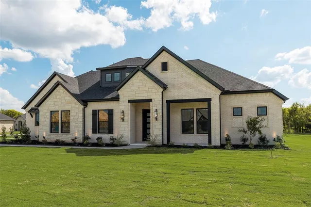 a front view of house with yard and green space