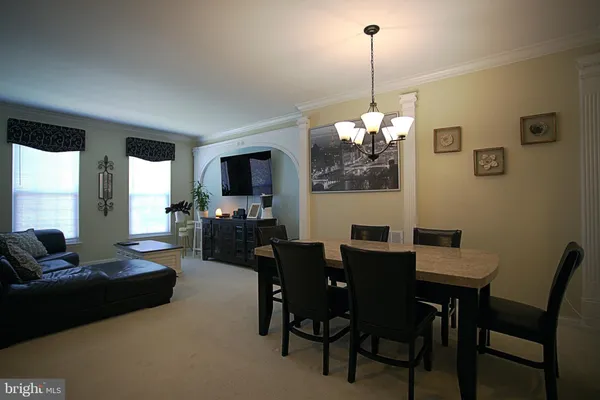 a view of a dining room with furniture and window