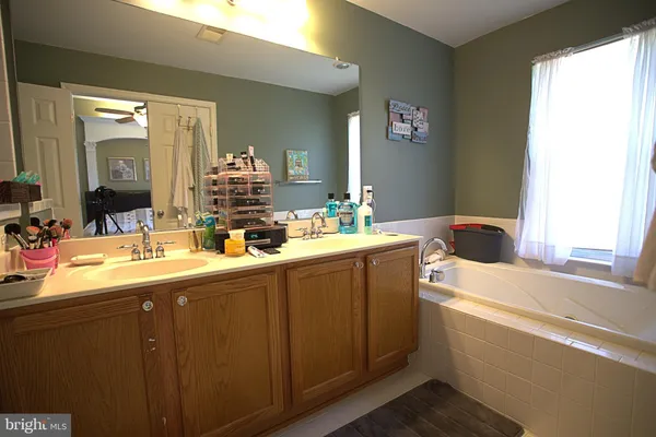 a bathroom with a double vanity sink and a mirror