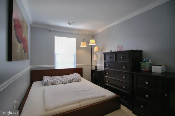a bedroom with a bed and a dresser