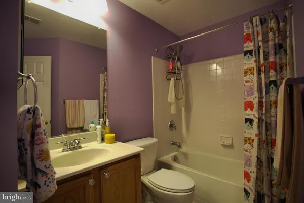a bathroom with a sink toilet tub and shower