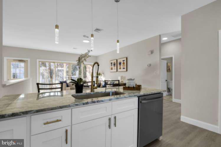 44 Buttonwood Street Mount Holly, NJ 08060 - Photo 12 of 31 a kitchen with granite countertop a sink and cabinets