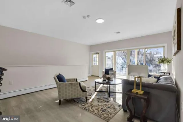 a living room with furniture and a lamp