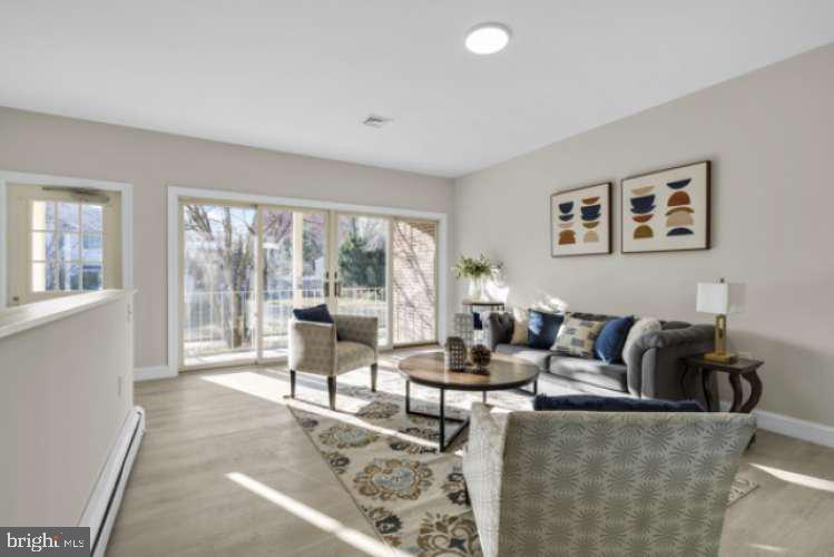 44 Buttonwood Street Mount Holly, NJ 08060 - Photo 14 of 31 a living room with furniture and large windows