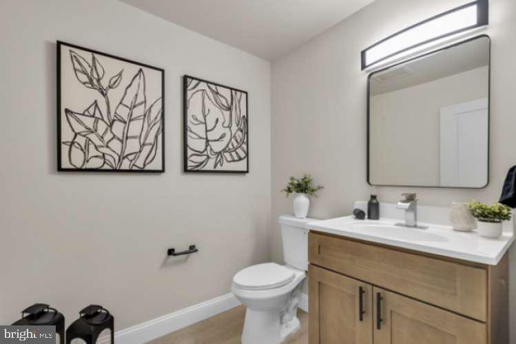 44 Buttonwood Street Mount Holly, NJ 08060 - Photo 26 of 31 a bathroom with a toilet sink and mirror