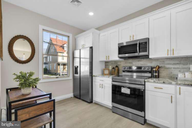 44 Buttonwood Street Mount Holly, NJ 08060 - Photo 10 of 31 a kitchen with a stove a sink and a microwave
