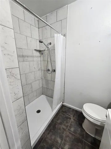 a bathroom with a shower and a toilet