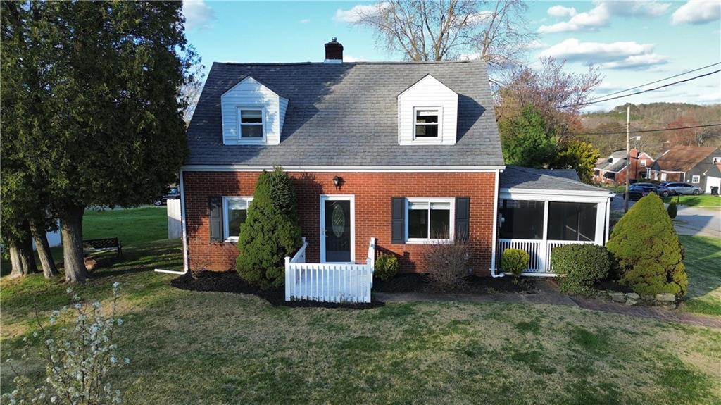 a front view of house with a garden