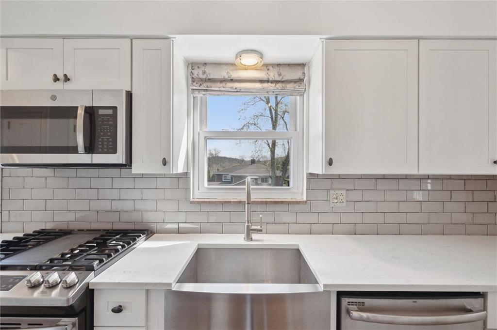 2936 Brodhead Road Aliquippa, PA 15001 - Photo 15 of 47 a kitchen with a sink a stove and cabinets