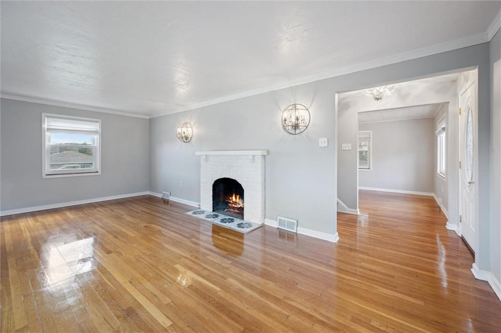 2936 Brodhead Road Aliquippa, PA 15001 - Photo 6 of 47 a view of empty room with wooden floor and fireplace