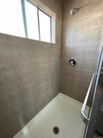 a bathroom with a tub a sink and a window