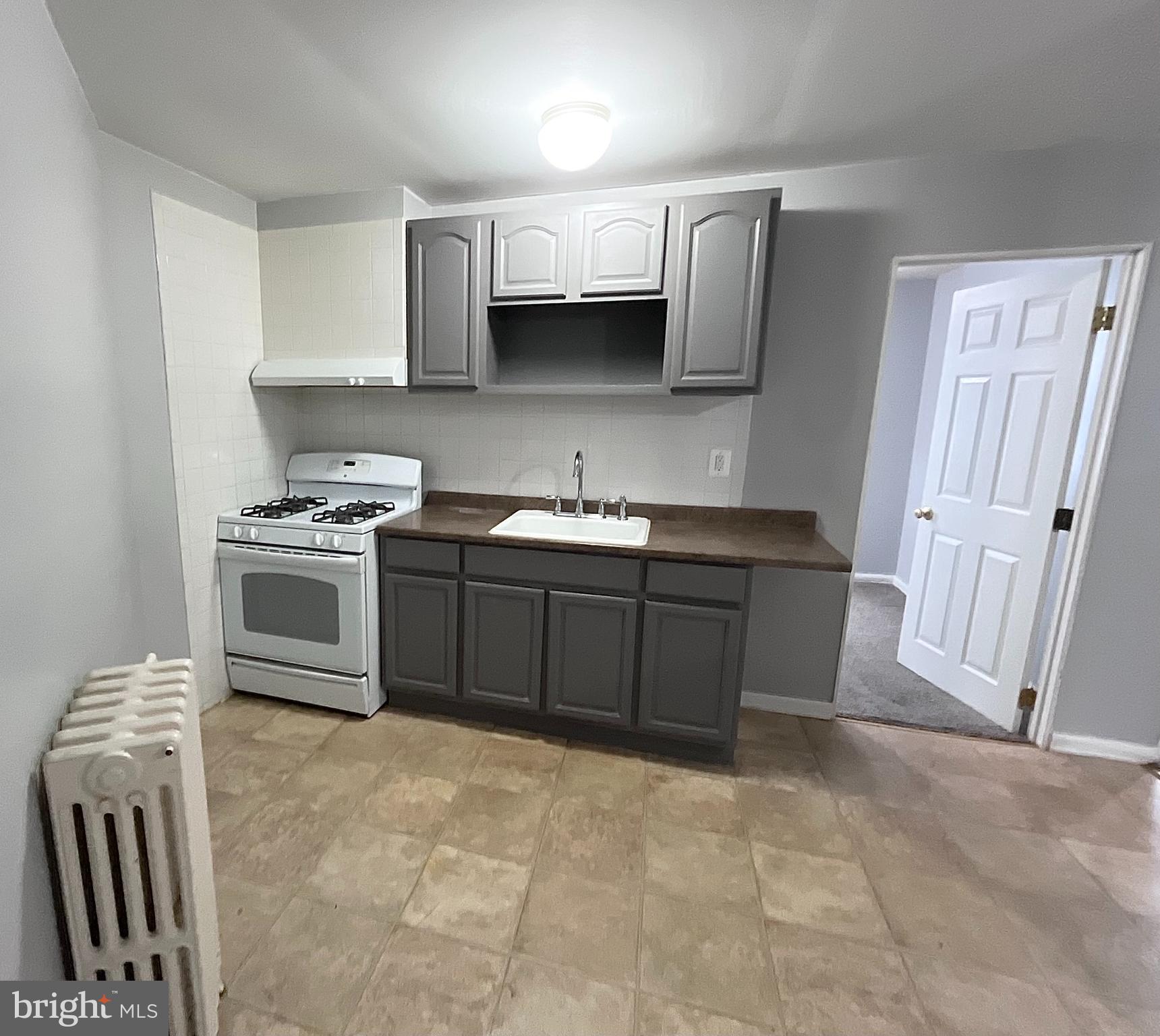 5615 Upland Way, Unit 2 Philadelphia, PA 19131 - Photo 5 of 10 a kitchen with stainless steel appliances a sink stove and cabinets