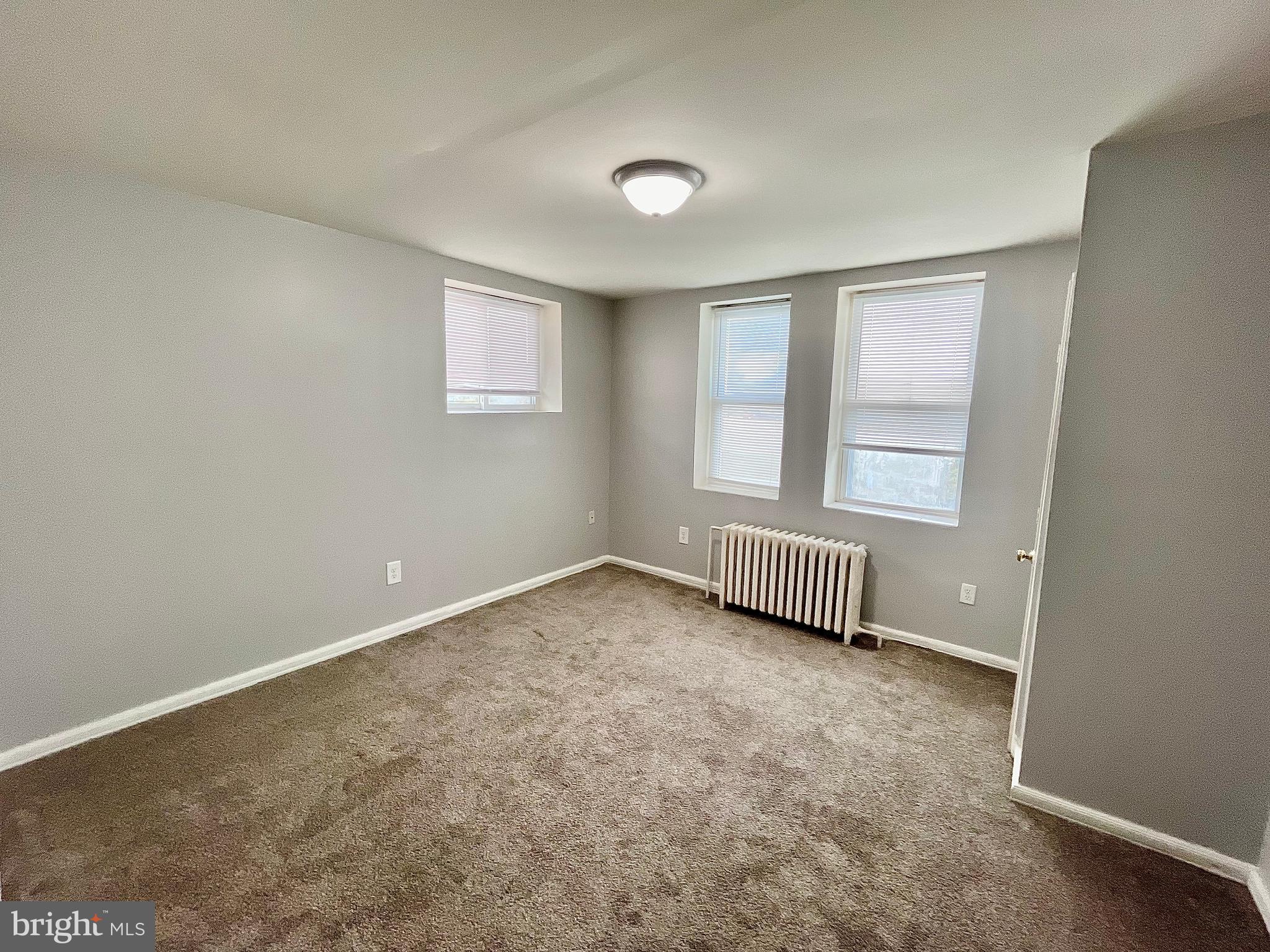 5615 Upland Way, Unit 2 Philadelphia, PA 19131 - Photo 6 of 10 an empty room with windows