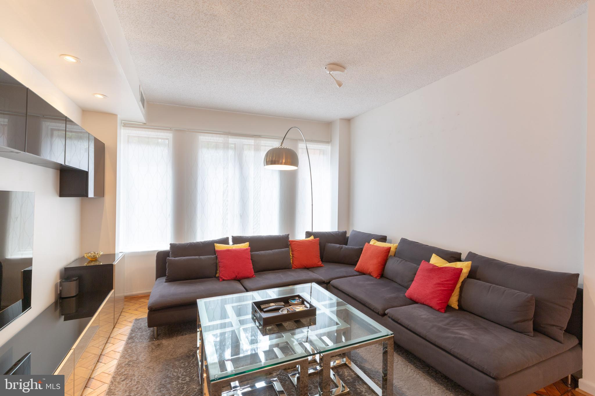 1045 31st Street Northwest, Unit 21 Washington, DC 20007 - Photo 18 of 35 a living room with furniture and a couch