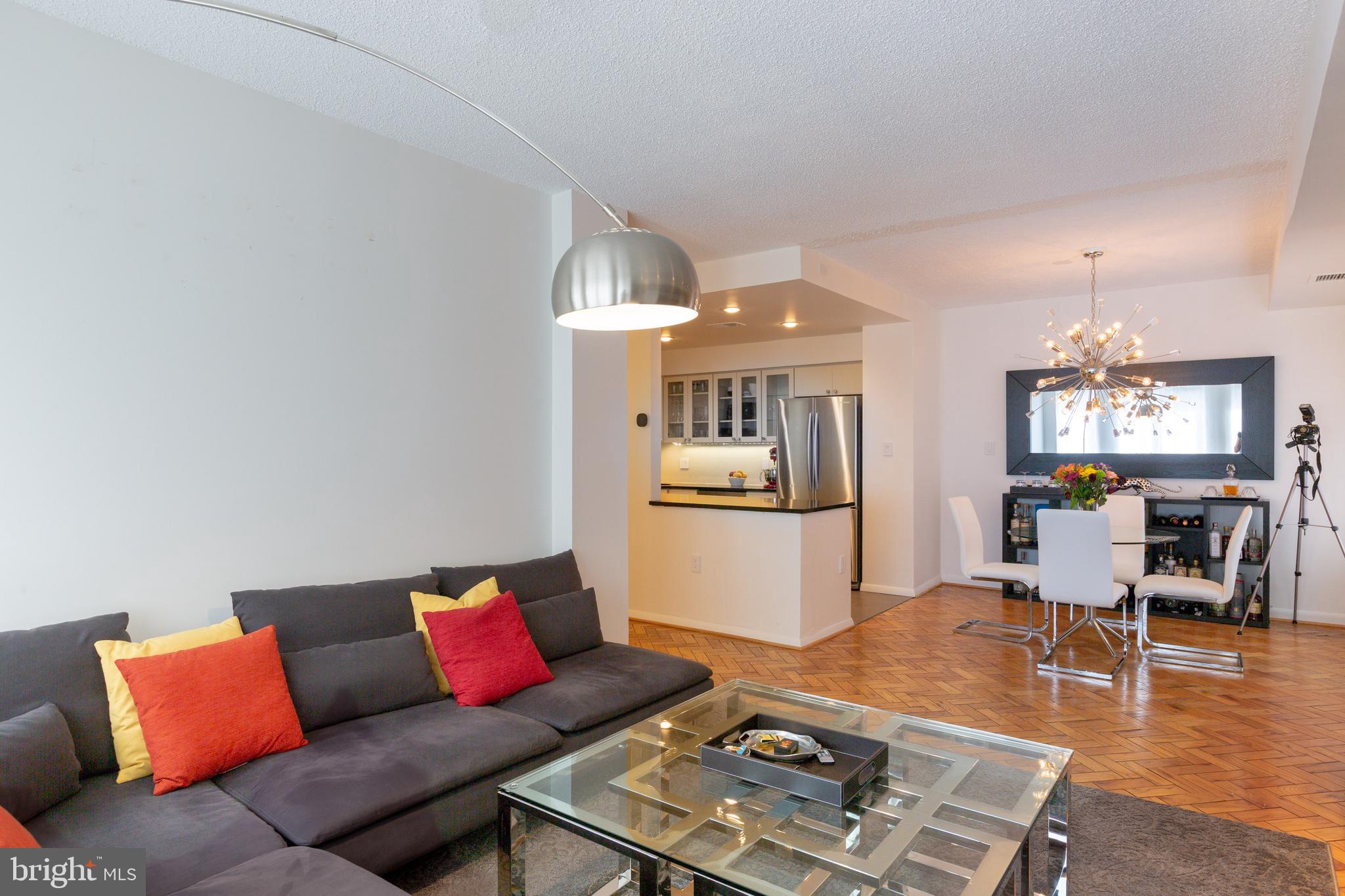 1045 31st Street Northwest, Unit 21 Washington, DC 20007 - Photo 19 of 35 a living room with furniture and wooden floor
