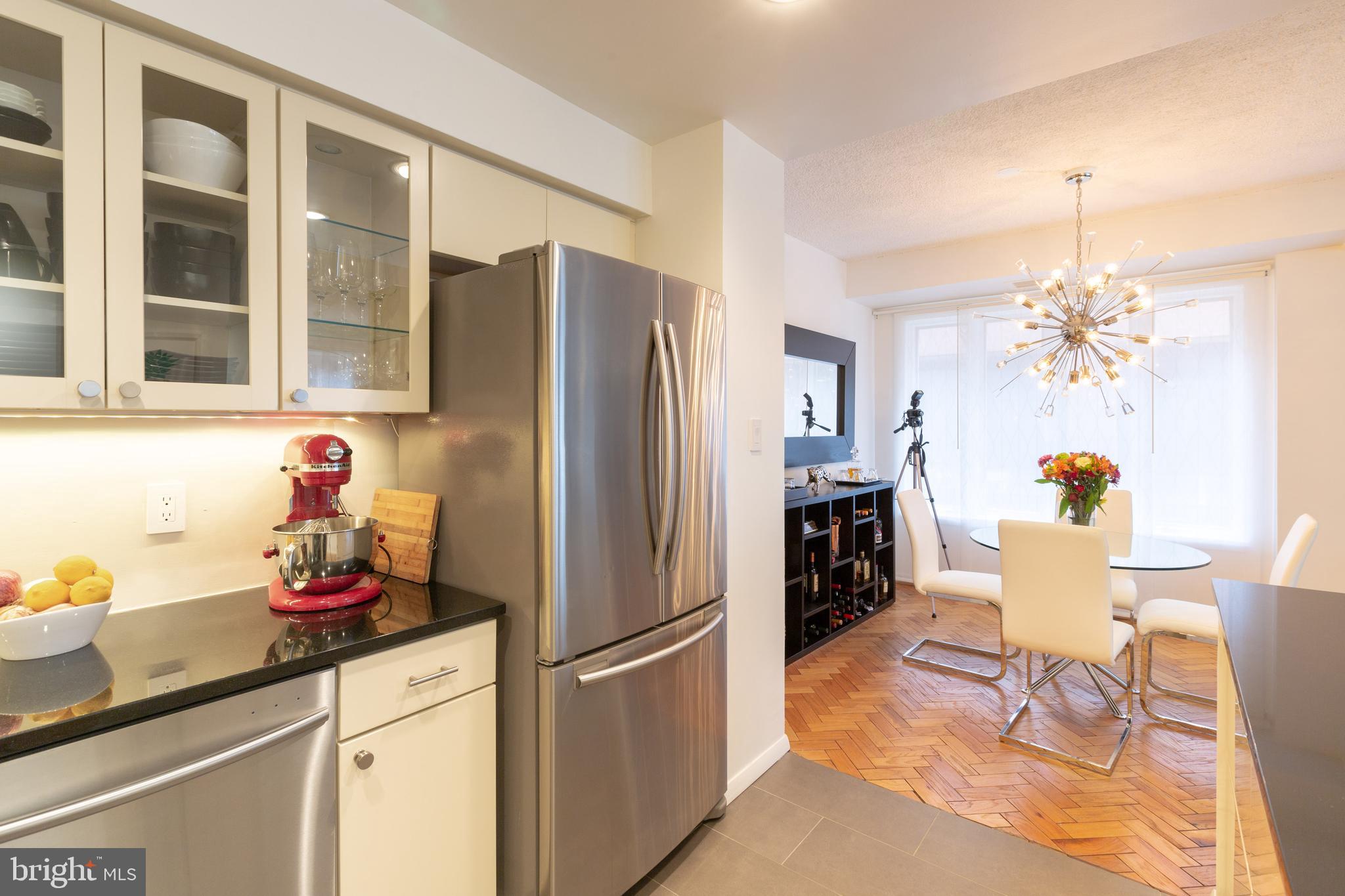 1045 31st Street Northwest, Unit 21 Washington, DC 20007 - Photo 21 of 35 a kitchen with stainless steel appliances granite countertop a refrigerator and a sink