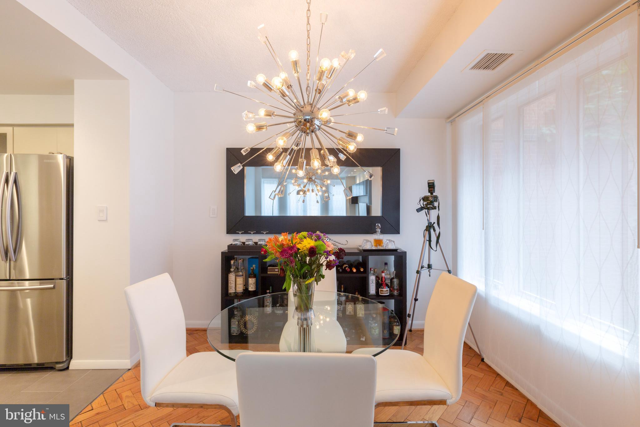 1045 31st Street Northwest, Unit 21 Washington, DC 20007 - Photo 23 of 35 a view of a dining room with furniture and chandelier