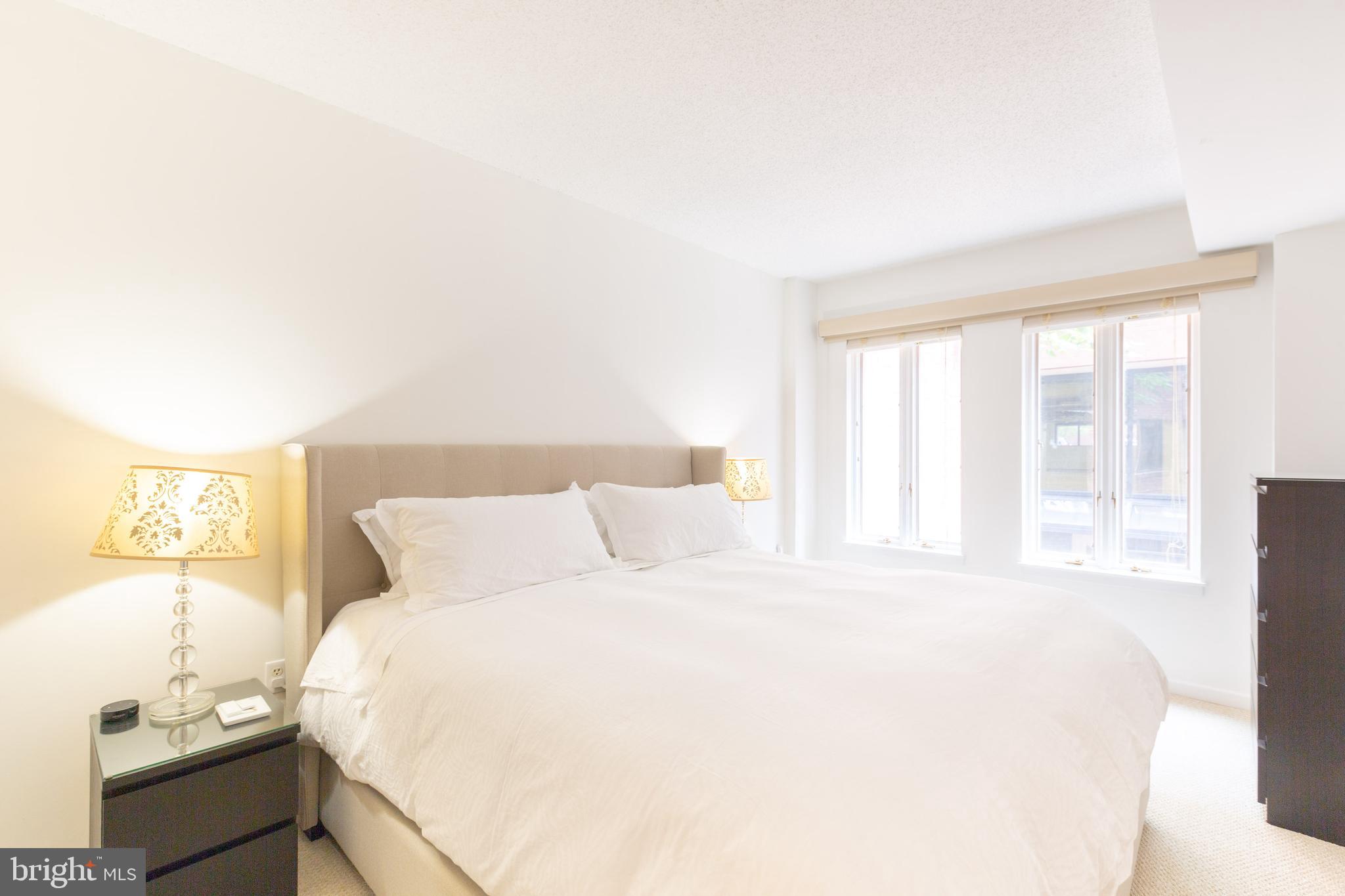 1045 31st Street Northwest, Unit 21 Washington, DC 20007 - Photo 26 of 35 a bedroom with a bed and a window