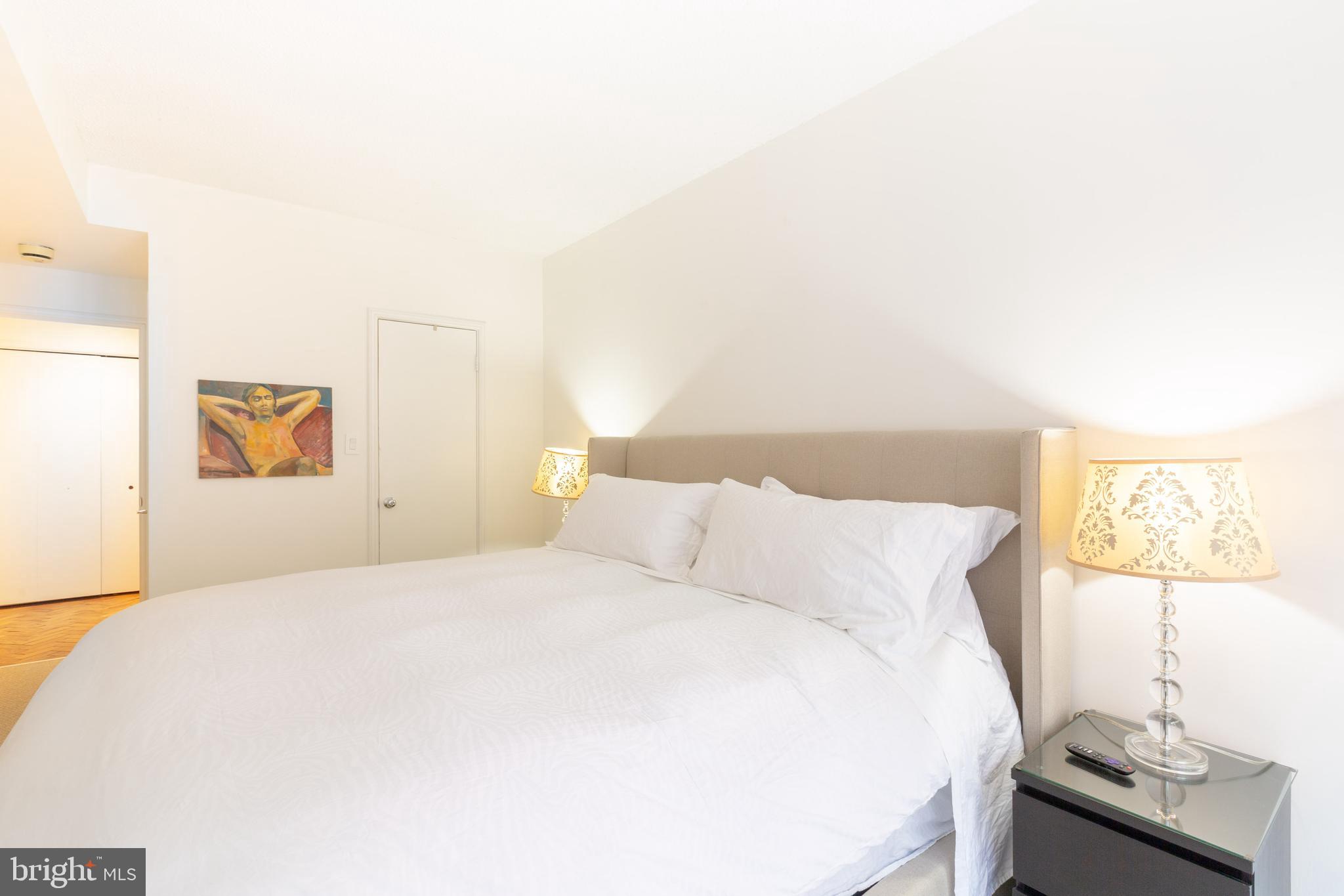 1045 31st Street Northwest, Unit 21 Washington, DC 20007 - Photo 27 of 35 a bedroom with a bed and a desk