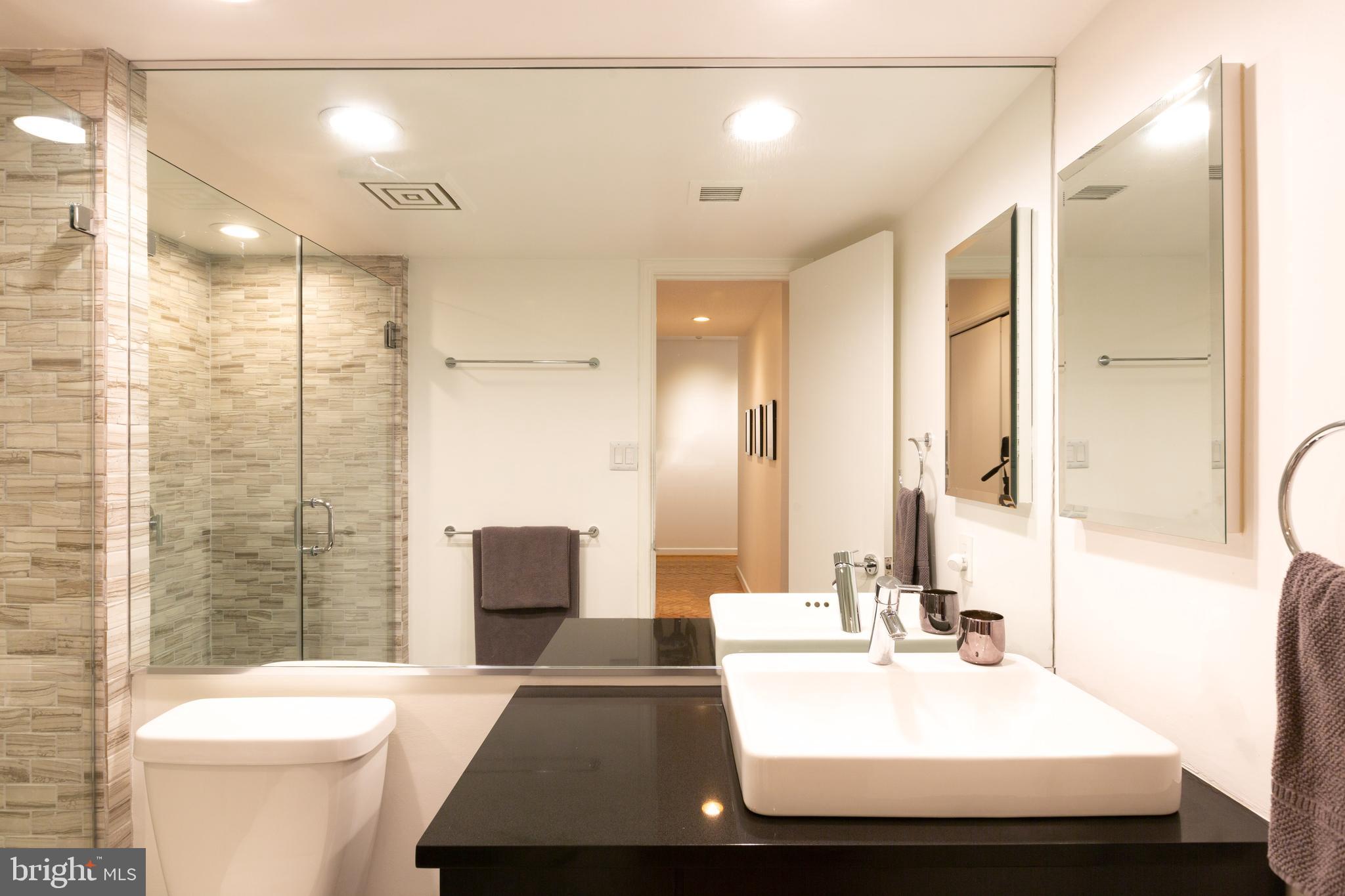 1045 31st Street Northwest, Unit 21 Washington, DC 20007 - Photo 29 of 35 a bathroom with a sink a toilet and shower