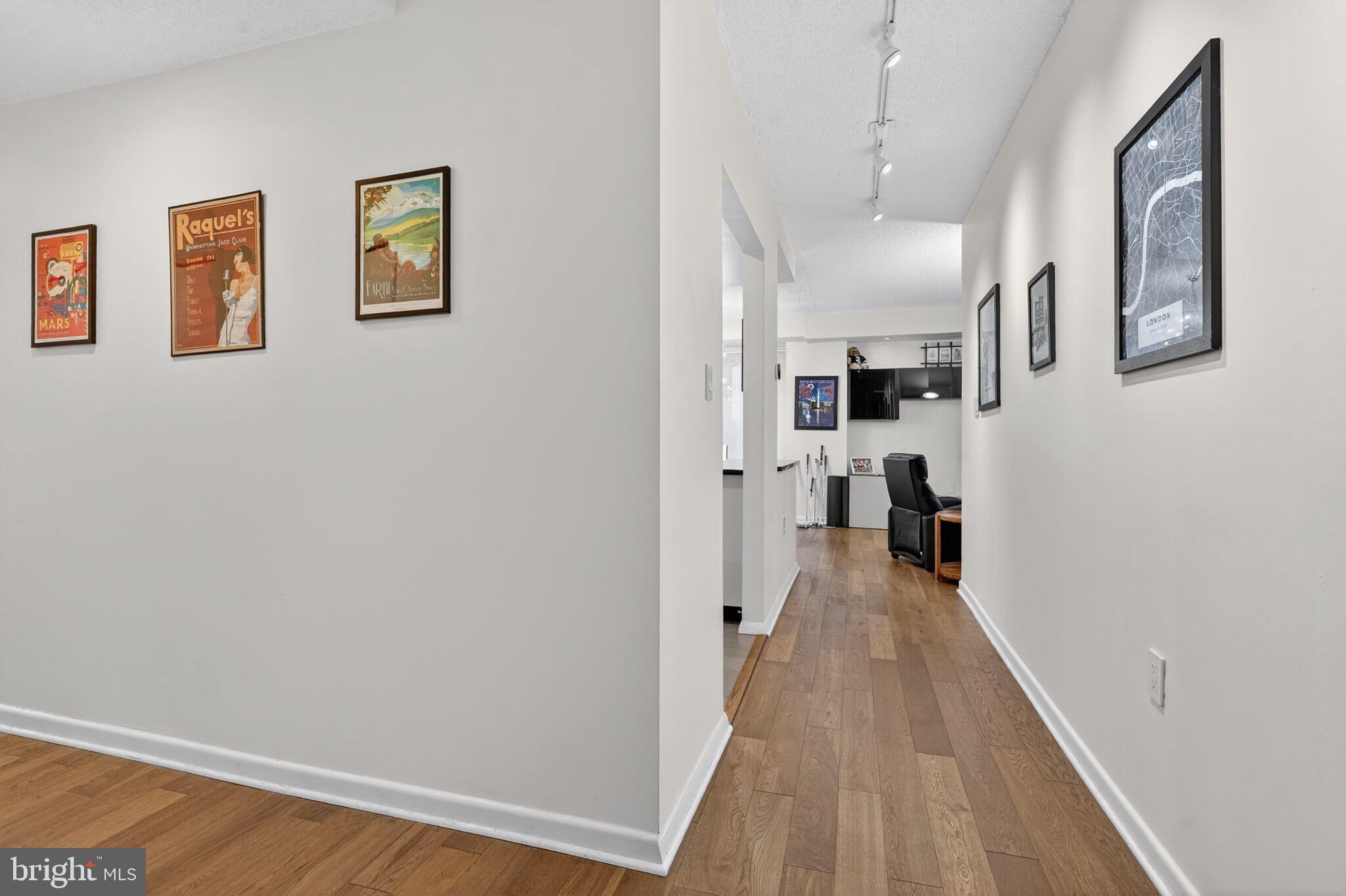 1045 31st Street Northwest, Unit 21 Washington, DC 20007 - Photo 3 of 35 a view of a hallway with wooden floor and living room