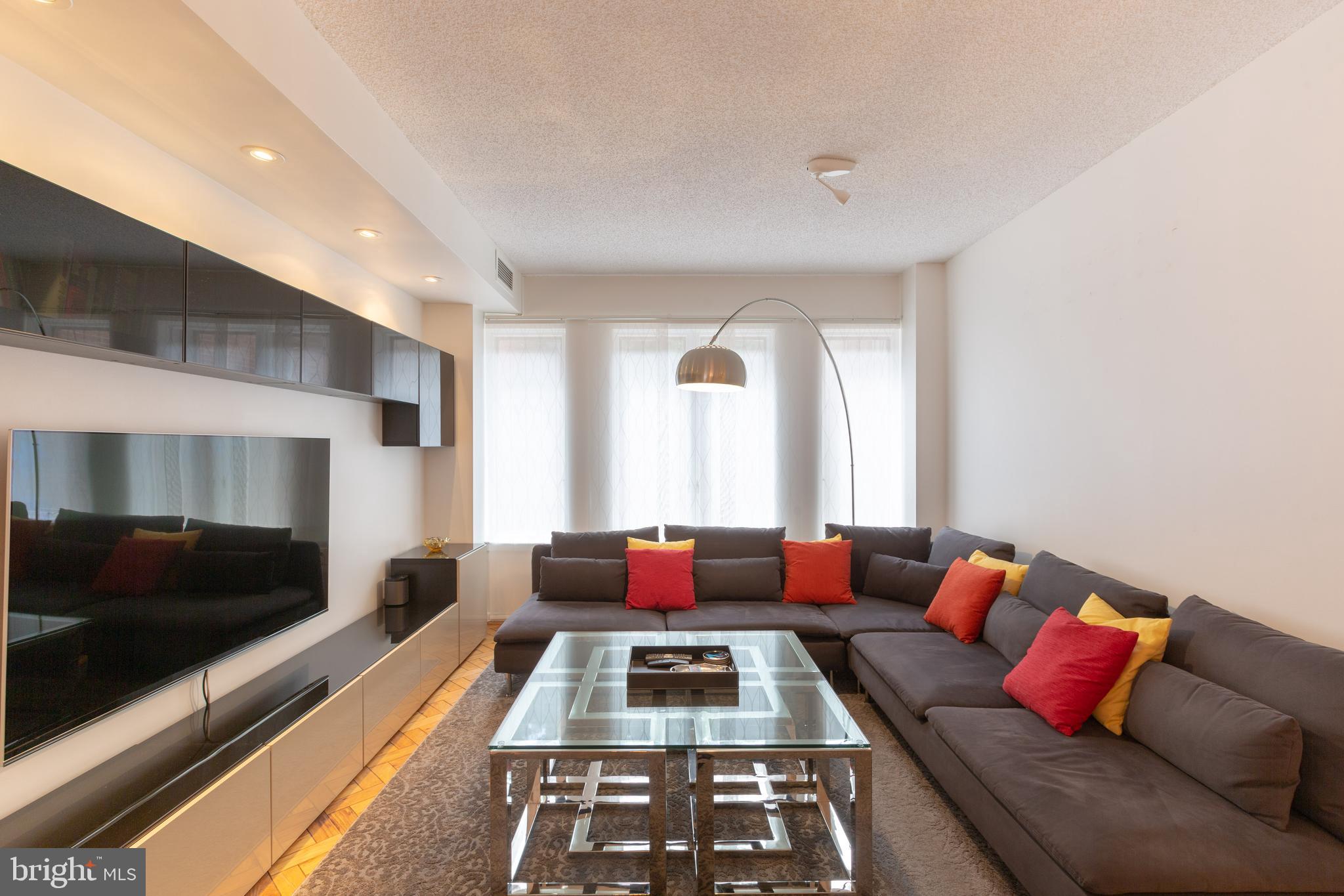 1045 31st Street Northwest, Unit 21 Washington, DC 20007 - Photo 8 of 35 a living room with furniture and a flat screen tv