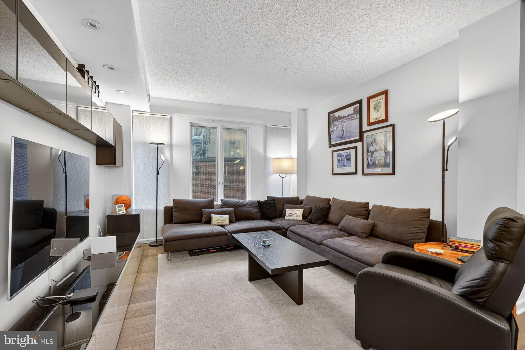 1045 31st Street Northwest, Unit 21 Washington, DC 20007 - Photo 9 of 35 a living room with furniture and a flat screen tv