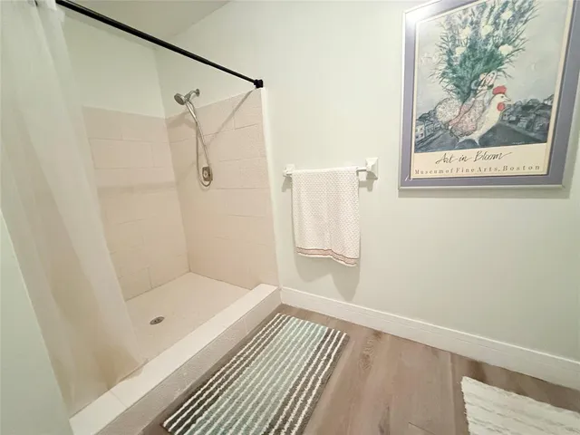 a bathroom with a glass shower door