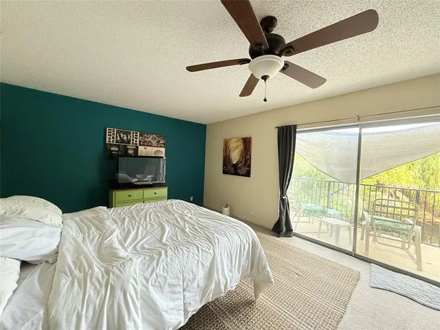 a bedroom with a bed and a large window