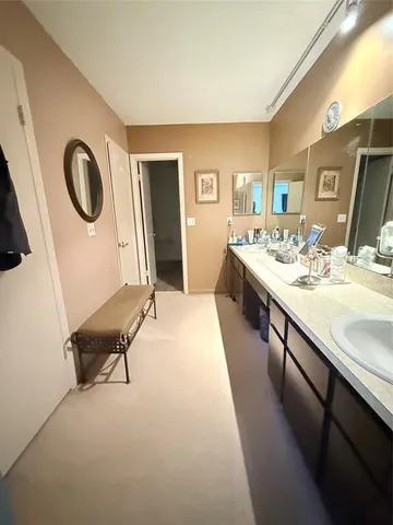 a spacious bathroom with a double vanity sink and a mirror