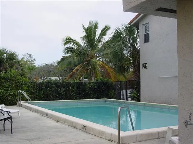 a view of a swimming pool with a yard