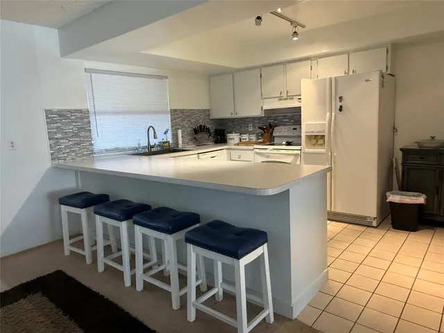 a living room with furniture a flat screen tv and a window