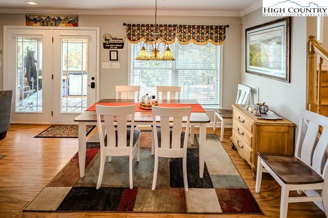 a view of a dining room with furniture wooden floor and a chandelier