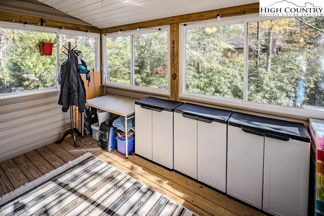 a view of a hallway with furniture and a window