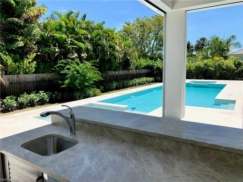 1670 Crayton Road Naples, FL 34102 - Photo 15 of 26 a view of swimming pool from a outdoor space