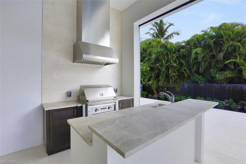 1670 Crayton Road Naples, FL 34102 - Photo 16 of 26 a kitchen with a stove and a white refrigerator