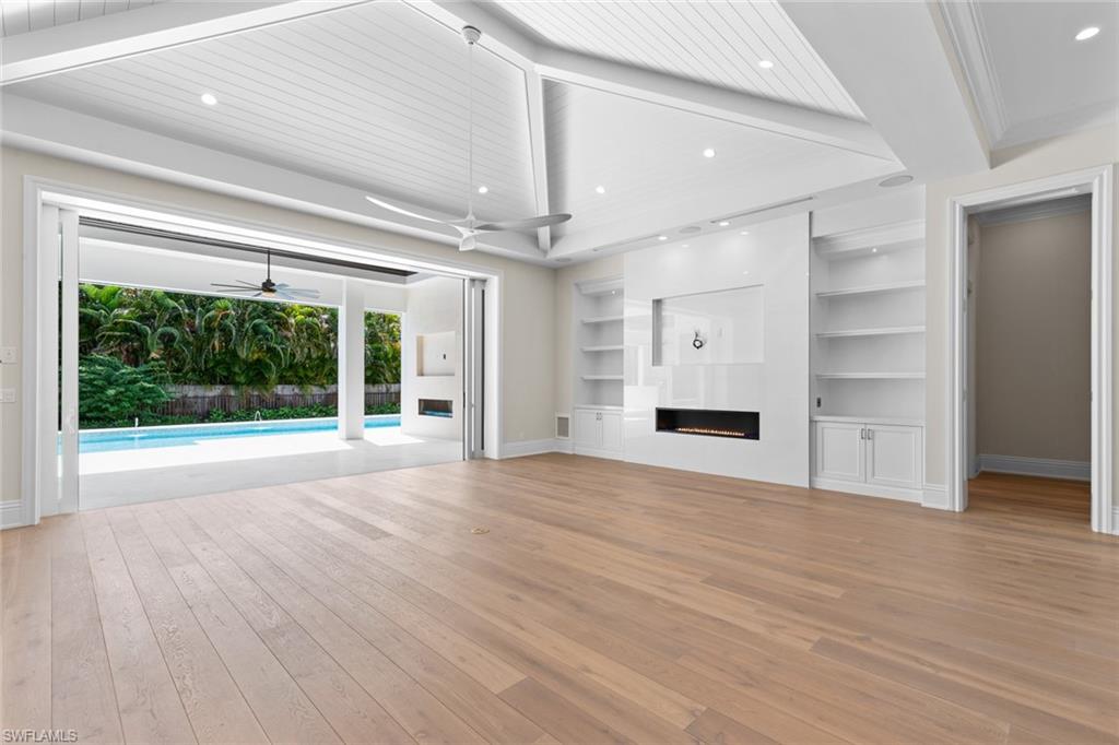 1670 Crayton Road Naples, FL 34102 - Photo 17 of 26 a view of an empty room with a window and wooden floor