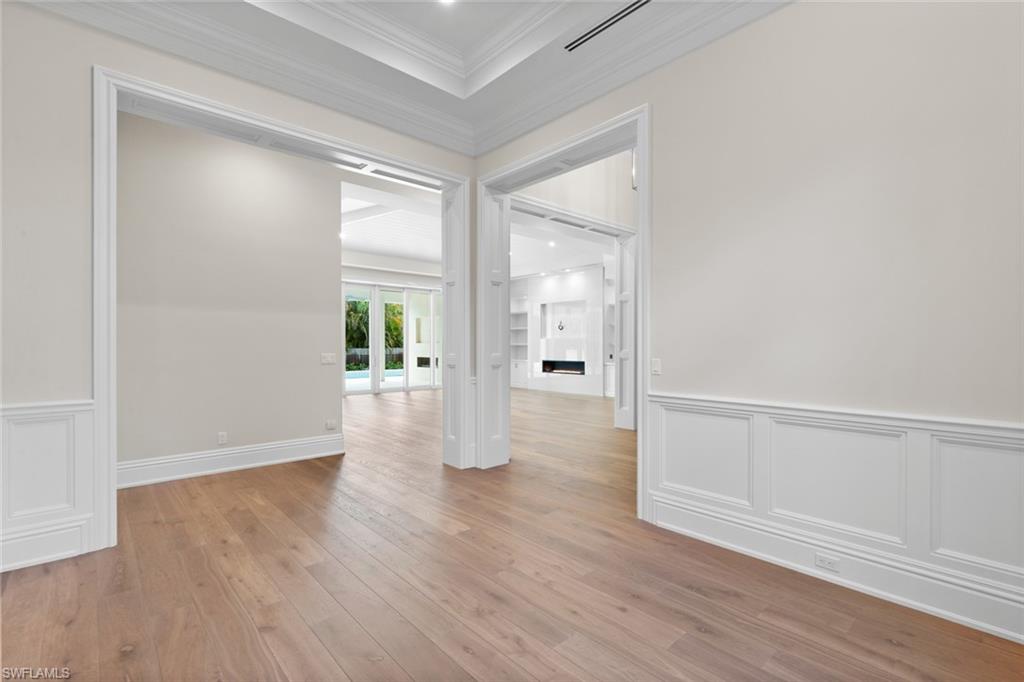 1670 Crayton Road Naples, FL 34102 - Photo 20 of 26 wooden floor in an empty room with a window