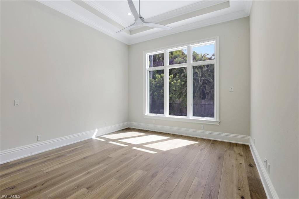 1670 Crayton Road Naples, FL 34102 - Photo 22 of 26 an empty room with wooden floor and windows