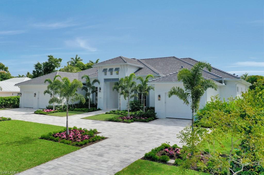 1670 Crayton Road Naples, FL 34102 - Photo 25 of 26 front view of a house with a yard