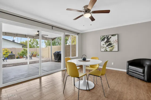 a dining room with furniture and a floor to ceiling window