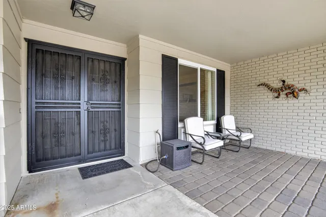 a kitchen with stainless steel appliances a refrigerator a stove a sink a dining table and chairs