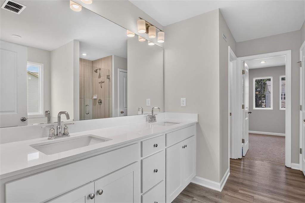 107 Ledgemont Way Acworth, GA 30101 - Photo 38 of 57 a bathroom with 2 sink and a mirror