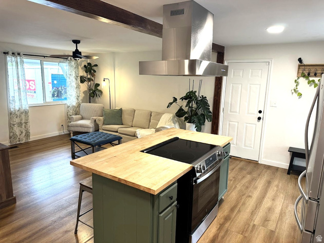 1791 West 170 South, Unit 8 Provo, UT 84601 - Photo 13 of 25 Open-concept living space featuring wood-finish flooring, a kitchen island with a wood countertop, and a stainless steel range hood