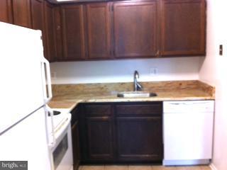 5758 Village Green Drive, Unit E Alexandria, VA 22309 - Photo 1 of 7 a kitchen with a sink and cabinets