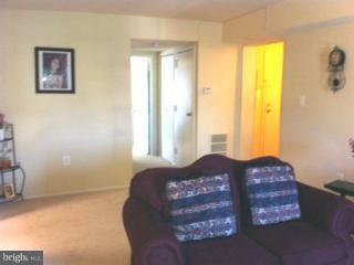 5758 Village Green Drive, Unit E Alexandria, VA 22309 - Photo 4 of 7 a large bed sitting in a bedroom next to a window