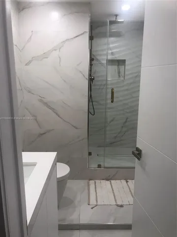 a bathroom with a shower and toilet