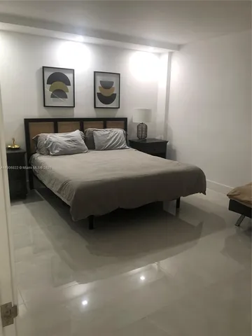 a bedroom with a bed and lamp